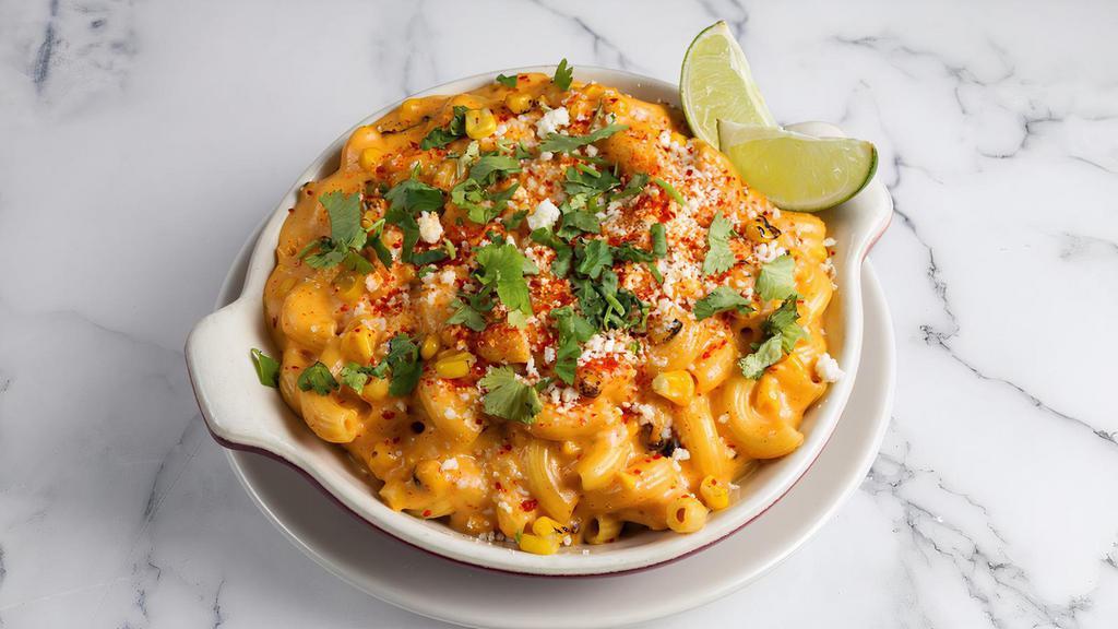 Elote Mac by Homeroom · By Homeroom. You'll love it elote. Roasted sweet corn, serrano peppers, cheddar and monterey jack. Topped with cotija, tajin, cilantro and lime. Contains gluten, dairy, and nightshades. We cannot make substitutions.