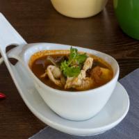 Tom Yum · Aromatic hot and sour soup with lemongrass, galangal, mushroom, tomatoes, and baby corn, cho...