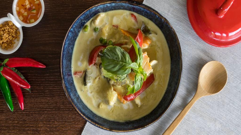 Green Curry · Thai green curry with coconut milk, bell peppers, eggplant, green beans, carrot, zucchini, bamboo shoot, and Thai basil with your choice of meat.