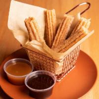 Churros · Freshly fried churros with chocolate and caramel sauce.  (5)-5 inch pieces.