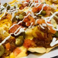Nachos · Nachos: Tortilla Chips, MO's chili, nacho cheese, onions, tomatoes, jalapeños, and banana pe...