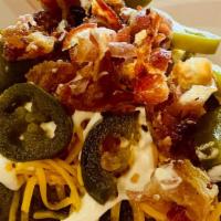 Fully Loaded Baked Potato · 9 oz Idaho potato, butter, sour cream, cheddar cheese, bacon bits, jalapeños, topped with MO...
