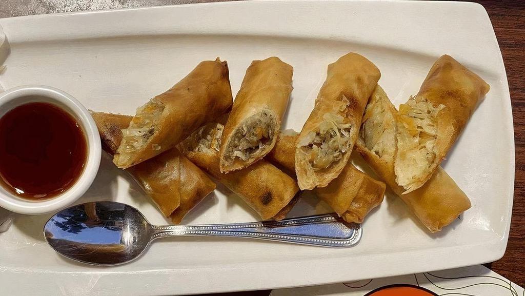 Crispy Egg Rolls / ปอเปี๊ยะทอด · Silver noodles, cabbage, carrots, onions, celery and shitake mushroom wrapped in egg roll paper served with sweet & sour sauce..