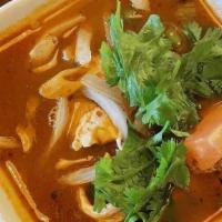 Tom Yum / ต้มยำ · Hot and sour soup with lemongrass, mushrooms, tomato, onions, and kaffir lime leaves.