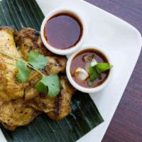 Grilled Chicken / ไก่ย่าง · Chicken Marinated with fresh thai herbs, salt, ground black pepper served with Thai spicy sa...