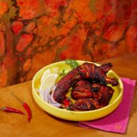 Tandoori Chicken · Spicy chicken with yogurt, ginger, garlic, and spices and char grilled in the tandoor grill.