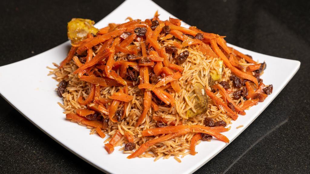 Qabili Palow · Seasoned lamb shank topped with delicately seasoned basmati rice, julienne carrots and raisins.