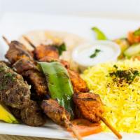 Two Meat Combo Kabob · Choice of any two kabobs topped with grilled onions & tomatoes over basmati saffron rice wit...