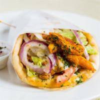 Chicken Gyros · Thin marinated slices of chicken, lettuce, tomatoes, onions topped with tzatziki sauce, on a...