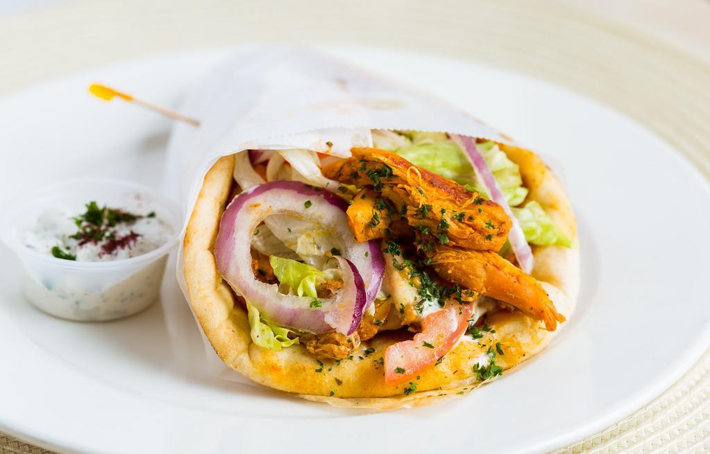 Chicken Gyros · Thin marinated slices of chicken, lettuce, tomatoes, onions topped with tzatziki sauce, on a thick pita bread.