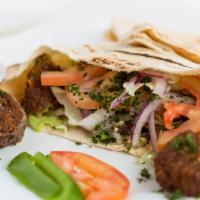 Falafel Wrap · Two falafels, lettuce, tomatoes, parsley, onions, topped with tahini sauce, in homemade pita...
