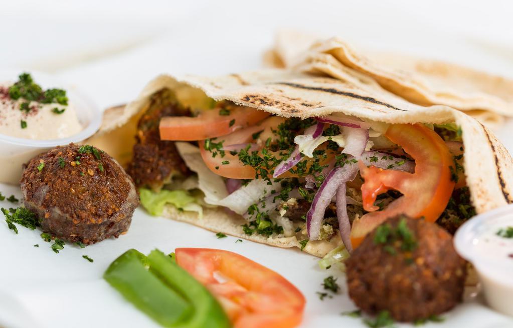 Falafel Wrap · Two falafels, lettuce, tomatoes, parsley, onions, topped with tahini sauce, in homemade pita bread.