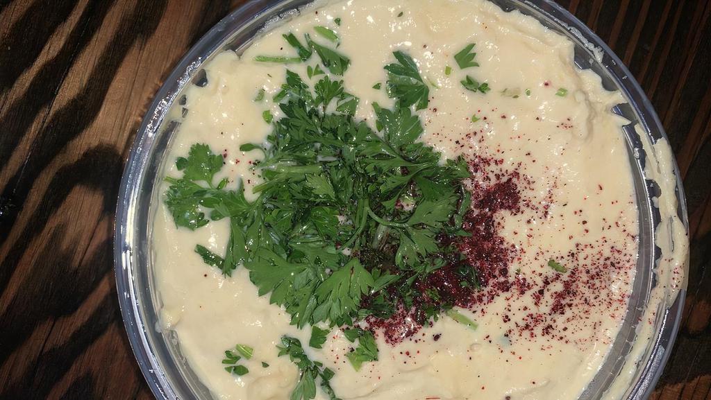 Hummus · Organic, garbanzo beans, lemon juice, fresh garlic, tahini sauce, topped with paprika, parsley & extra virgin olive oil.