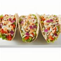 Korean Tacos · Spicy chicken or marinated ribeye over three flour tortillas. Topped with lettuce, coleslaw,...