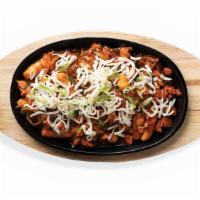 Bull Dak · Spicy chicken stir-fried with rice cakes, onions, and hot pepper sauce, topped with thinly s...