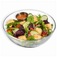 Sesame Ginger Salad · Spring mix, onions, sesame seeds, red bell peppers, and cucumbers topped with a sesame ginge...