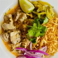 Khao Soi · A curry noodle dish from northern Thailand.  Coconut curry base with chicken, egg noodle, ci...