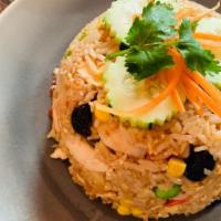 Pineapple Fried Rice · Egg, pineapple, pea, carrot, onion, cashew nut, and cranberry with yellow curry powder.