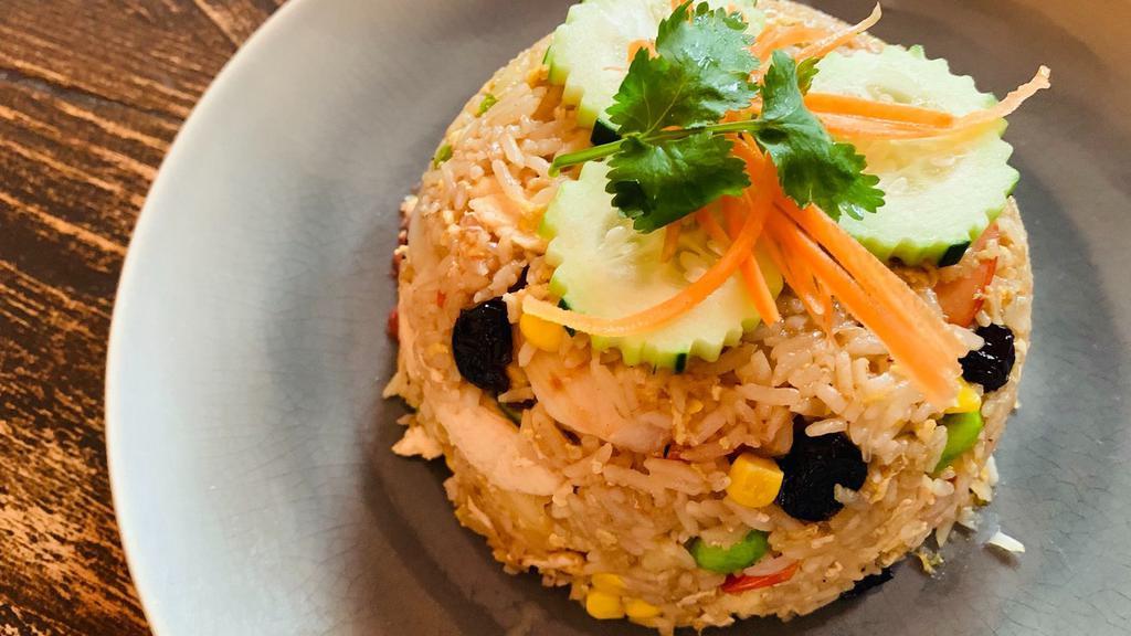 Pineapple Fried Rice · Egg, pineapple, pea, carrot, onion, cashew nut, and cranberry with yellow curry powder.
