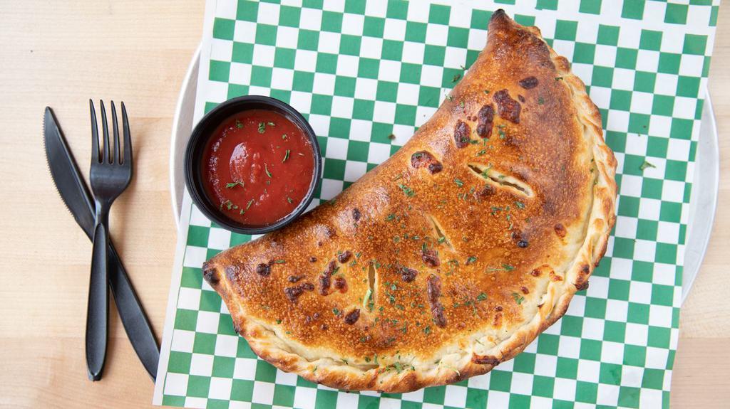 Meat Calzone · Cheese zone with pepperoni, sausage, meatball, ham & bacon.