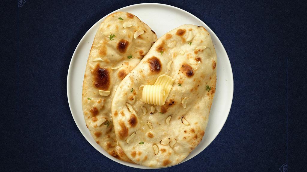 Garlic Naan Nation  · Freshly baked bread in a clay oven garnished with garlic and butter.