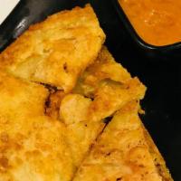 J5 Flaky Hand-Pulled Roti · Indian roti served with peanut curry sauce.