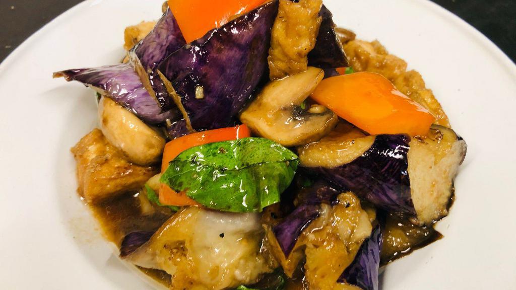 J23 Eggplant Tofu · Asian eggplant wok-tossed with black bean sauce, mushroom, red bell, and basil.