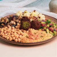 Hummus Veggie Plate · Hummus with falafel, grilled eggplant, charred cauliflower, and Mediterranean salad.