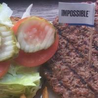 Impossible Burger · Plant-based, vegan, gluten-free burger alternative, lettuce, tomatoes, pickles, toasted bun.