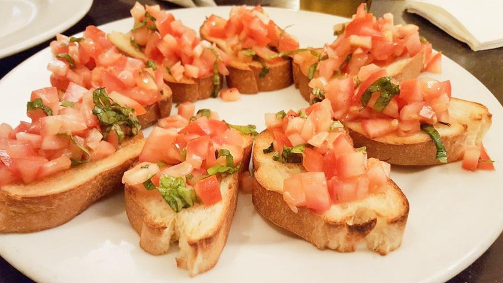 Bruschetta · Diced tomatoes, basil and extra virgin olive oil in a toasted Parisian bread.