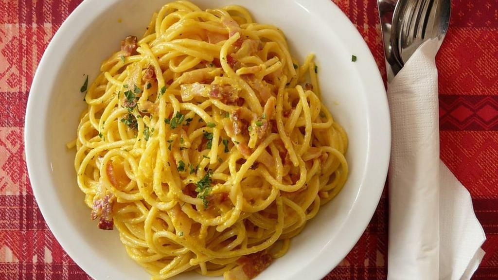 Spaghetti Carbonara · With diced ham and peas in sauce.