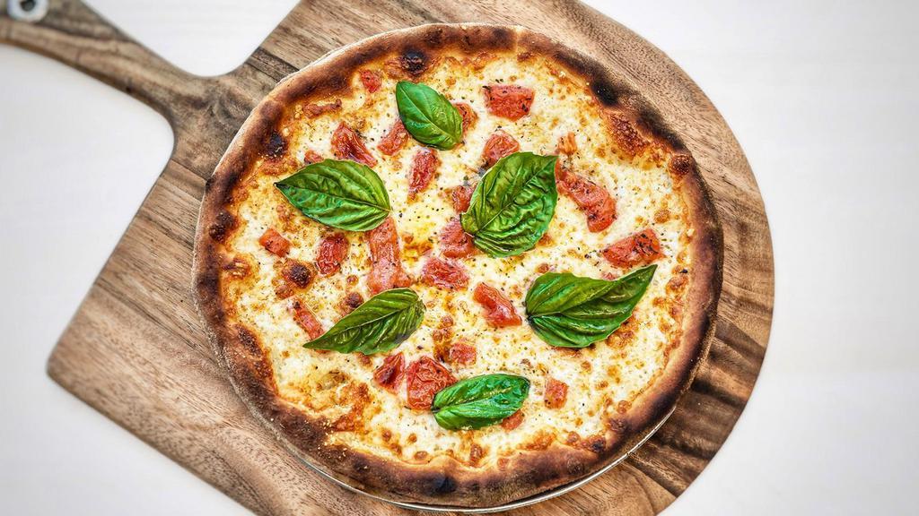 Margherita Thin Pizza · mozzarella, tomatoes, fresh basil, olive oil (tomato sauce optional)