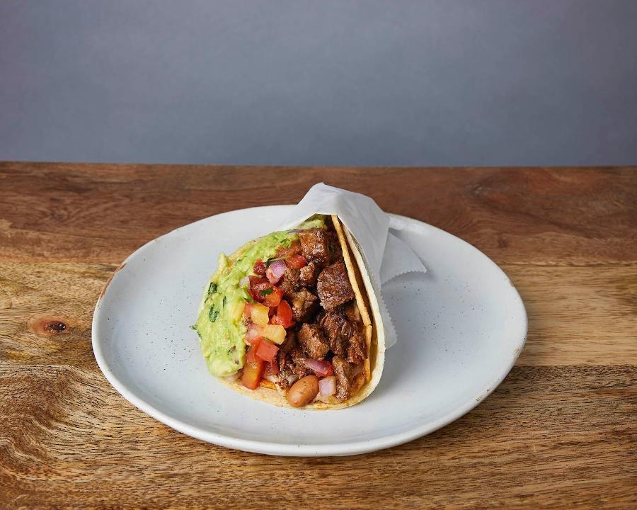 NICK'S WAY CARNE ASADA :: · One taco with a grilled crispy corn tortilla wrapped in a soft corn tortilla. With Jack cheese, pinto beans, pico de gallo, & guacamole