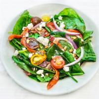 SPINACH SALAD · With roasted red peppers, red onion, tomato, bacon, crumbled feta, toasted pine nuts. Served...