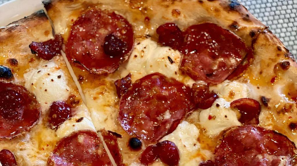 Cherry Soppressata Pizza · Cherries, smoked mozzarella, goat cheese, soppressata, calabrian chili honey drizzle