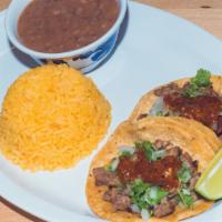 Taco Plate · Two corn tortilla tacos served with beans and rice with your choice of meat.