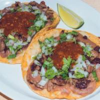 Super Tacos · Corn tortillas with beans, cheese and choice of meat.