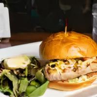 Ahi Tuna Steak Burger · Grilled ahi tuna seared rare, topped with Latin coleslaw, tomato, and sriracha mayo on an eg...