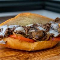 Ziggy's Cheesesteak Sandwich · Thinly sliced halal rib eye steak, grilled onions, sautéed mushrooms, tomato and melted prov...