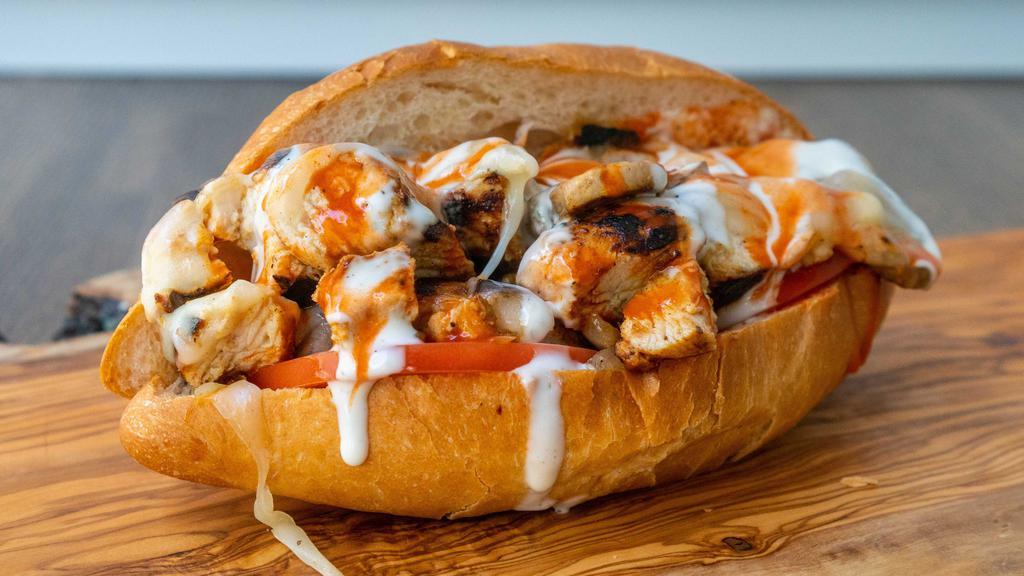 Buffalo Chicken Cheesesteak Sandwich · Grilled all natural halal chicken marinated in buffalo wing sauce, with grilled onions, sautéed mushrooms, tomato, topped with melted provolone cheese and ranch in a torpedo roll.