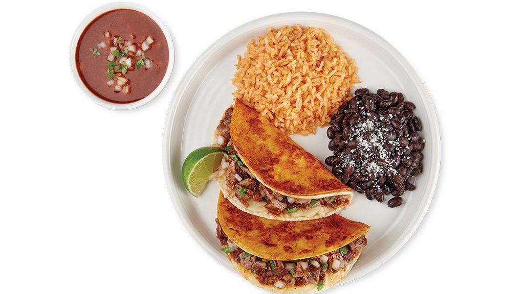 Birria Tacos · Made with chile-soaked corn tortillas stuffed with marinated steak, cheese, salsa 6 chiles and onion & cilantro mix. Served with a side of rich and mild savory chile beef consomé for dipping, rice and choice of black or pinto beans.