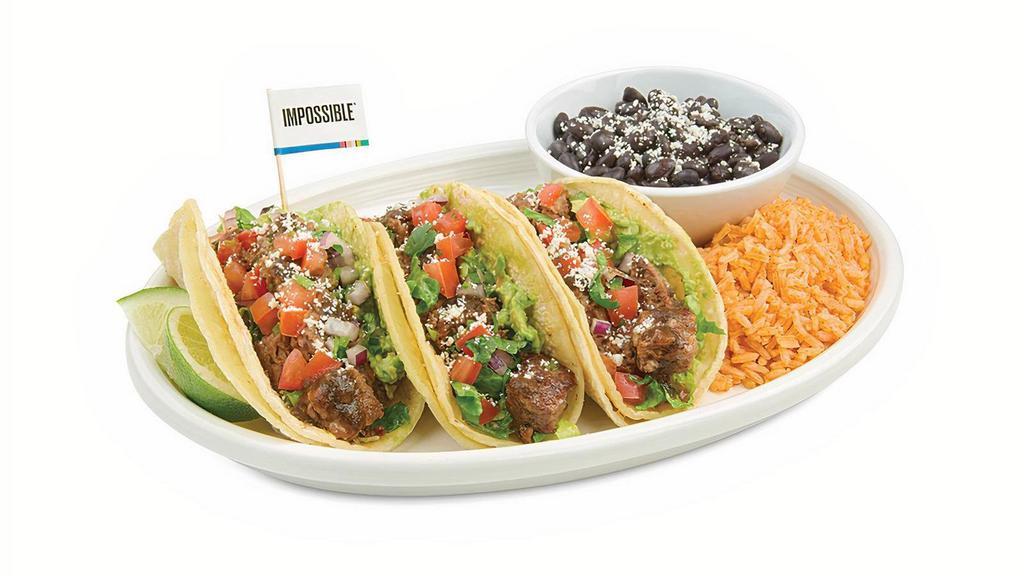 Impossible™ Taco · Warm, soft grilled corn tortillas filled with delicious Impossible meat made from plants topped with shredded lettuce, Pico de Gallo, guacamole, Baja Salsa, and cotija cheese.