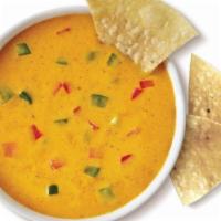 Queso (8Oz)  And Chips · 8 oz of spicy three pepper cheese dip. Served warm with freshly made tortilla chips.