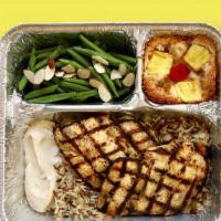 Tv Dinner Grilled Lemon Chicken · Hearty meals made in-house, frozen in retro-style trays, and ready to pop in the oven when y...