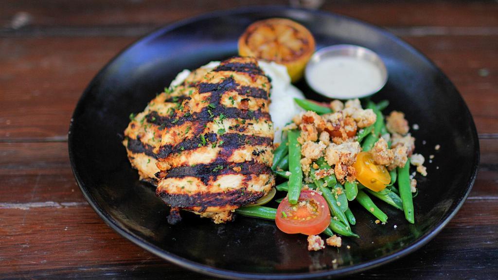 Grilled Lemon Chicken Meal · marinated + grilled boneless chicken breasts, mashed potatoes, sautéed green beans, heirloom tomatoes, sliced almonds, citrus cream sauce on the side