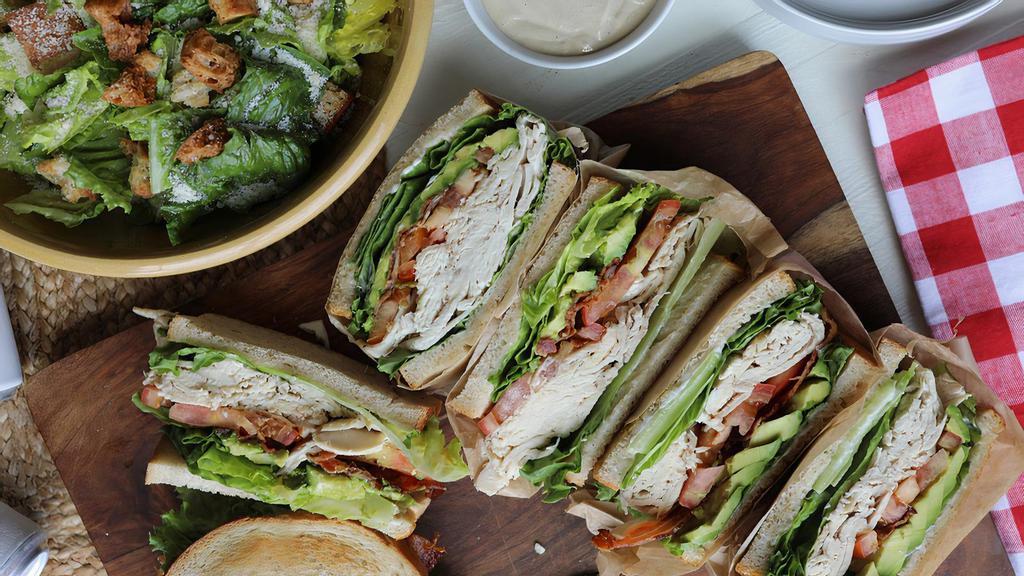 House Club Sandwich Meal · In-house roasted chicken breast, smoked bacon, avocado, lettuce, tomato, mayo, toasted sourdough // family-style caesar salad with our housemade dressing, garlic croutons + parmesan