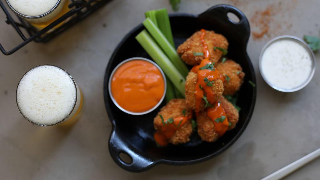 Buffalo Chicken Nuggets · hand-breaded chicken nuggets tossed in cajun spices, drizzled with high altitude hot sauce, celery + ranch [1390 cal] .