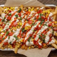 Street Corn Fries · crispy french fries topped with melted mozzarella, tajin-lime sauce, charred sweet corn, tom...