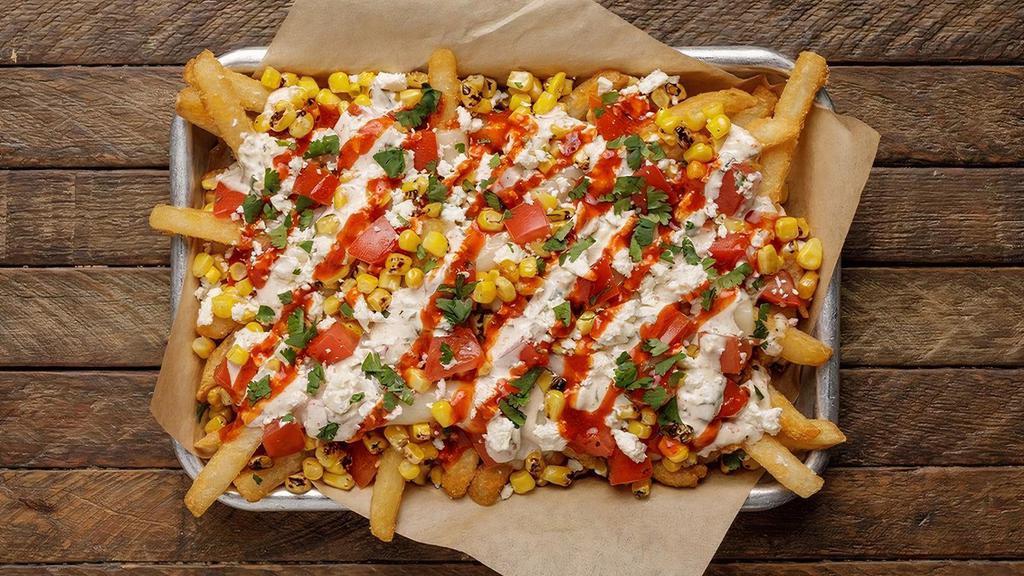 Street Corn Fries · crispy french fries topped with melted mozzarella, tajin-lime sauce, charred sweet corn, tomatoes, queso blanco + fresh cilantro [1700 cal]