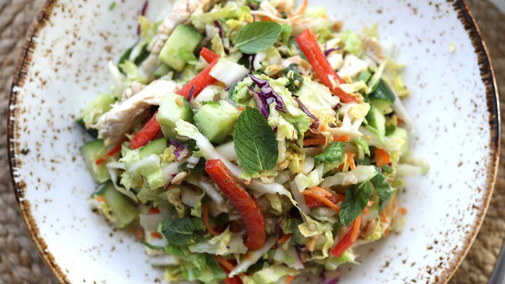 Thai Chicken Salad · hand-shredded chicken breast, chopped napa cabbage, mint, cilantro, carrots, red bell peppers, cucumbers, spicy peanut vinaigrette [440 cal] .